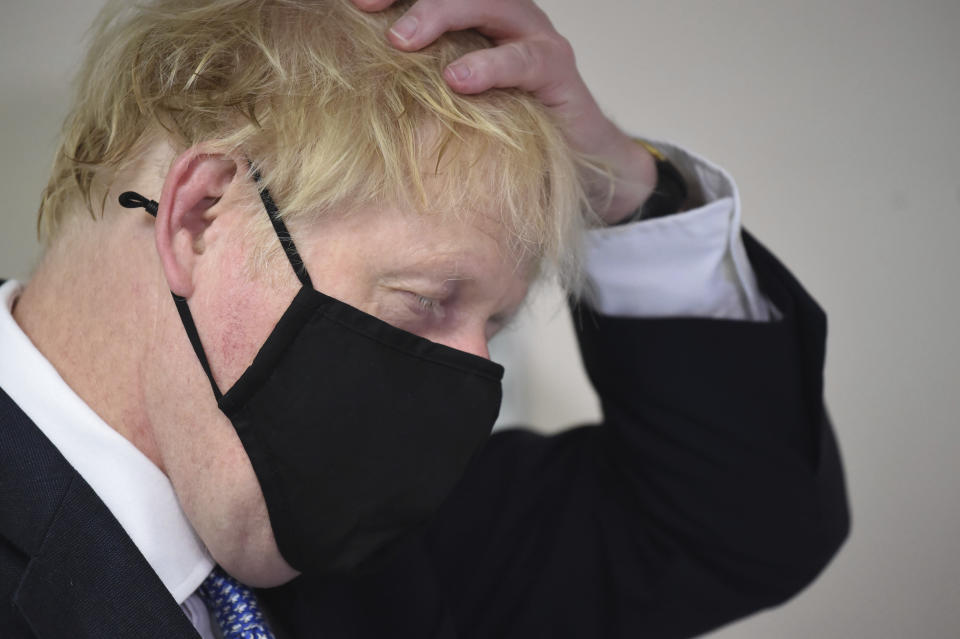 Britain's Prime Minister Boris Johnson gestures, during a visit to Tollgate Medical Centre in Beckton, East London, Friday July 24, 2020. (Jeremy Selwyn/Pool Photo via AP)