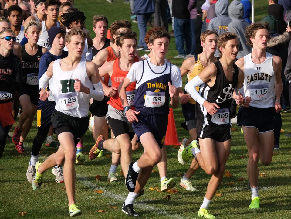 The leaders are bunched together as they go into the first turn in the Boys Greater Lansing Cross Country Championship race Saturday, Oct. 15, 2022.