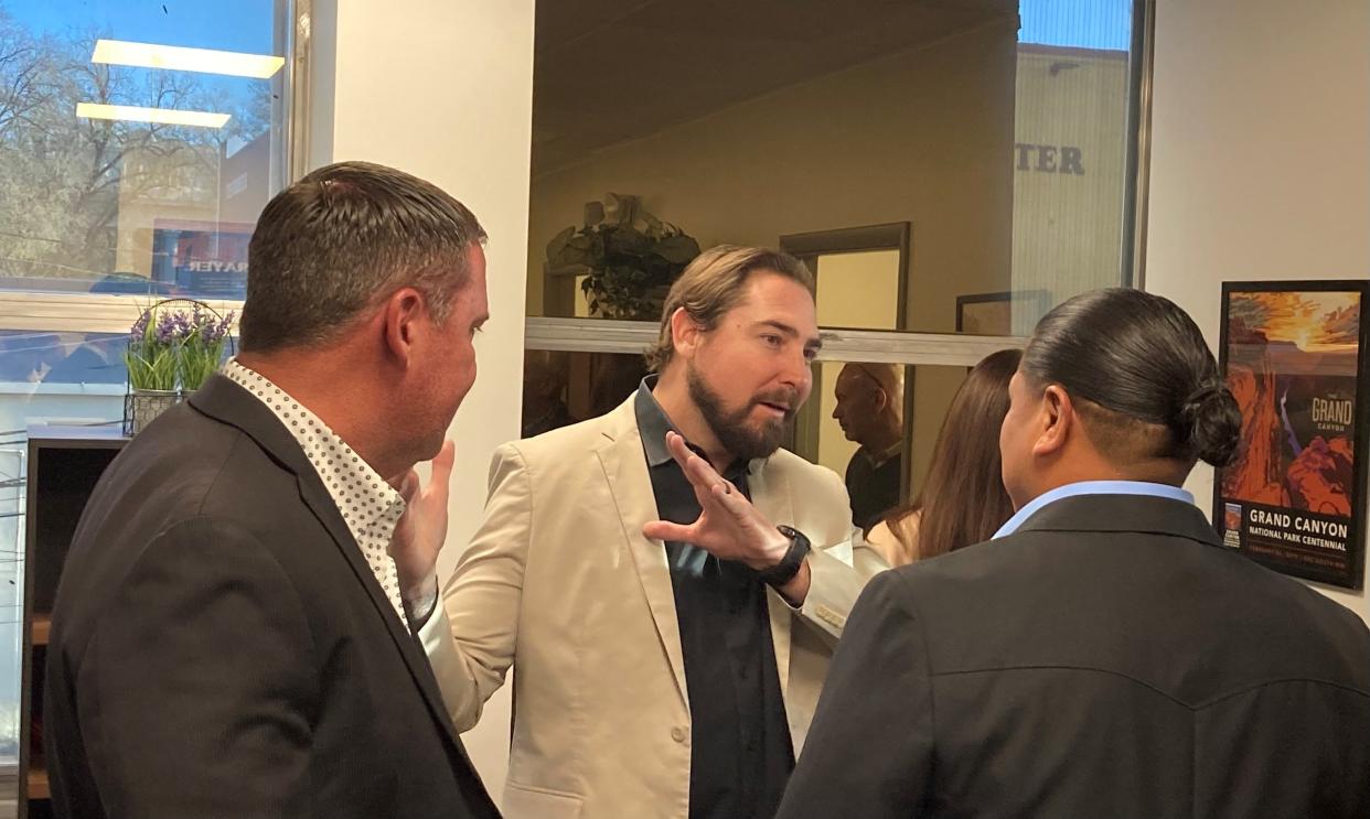 U.S. Rep. Eli Crane, R-Ariz., speaks to San Juan Southern Paiute President Johnny Lehi Jr. while his district director Gaither Martin looks on, April 13, 2023, during an open house at Crane's Prescott office.