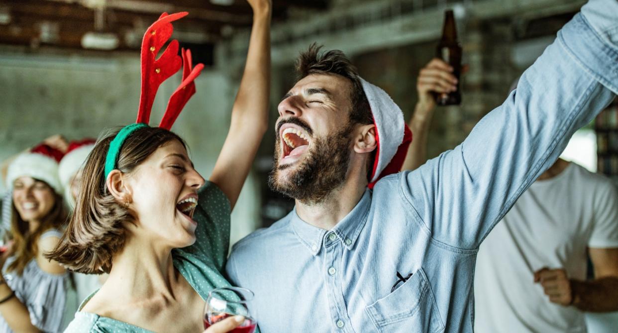 Man and woman dancing at Christmas party. An etiquette expert says drinking too much is a no-no. (Getty Images)