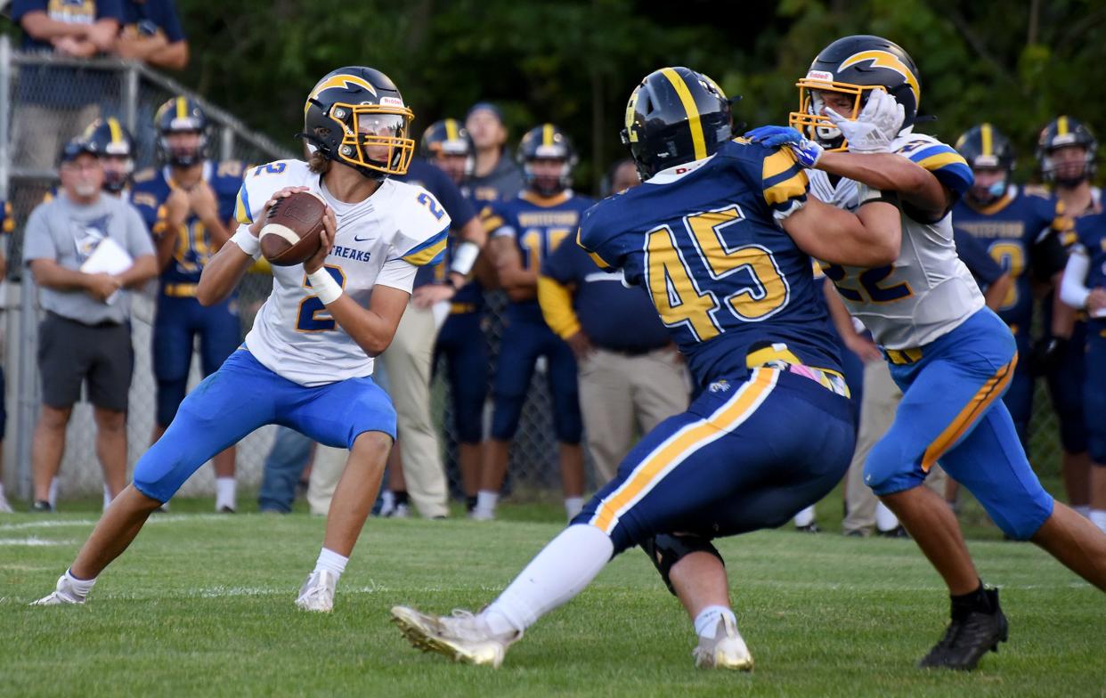 Ida quarterback Owen Snyder of Ida sets to throw, as Trevor Konieczny of Ida blocks Whiteford's Drew Knaggs during a 22-7 Whiteford win Thursday night.