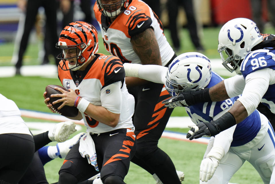 Cincinnati Bengals quarterback Joe Burrow (9) is sacked by dIndianapolis Colts' DeForest Buckner (99) during the second half of an NFL football game, Sunday, Oct. 18, 2020, in Indianapolis. (AP Photo/AJ Mast)