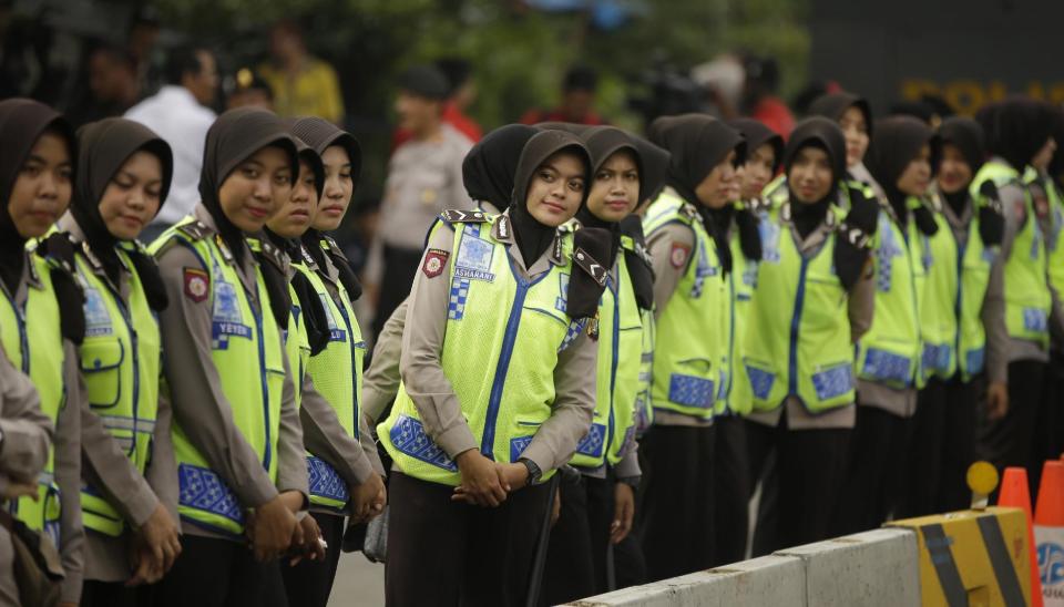 In this Tuesday, Jan. 3, 2017 photo, Muslim police officers line up outside the North Jakarta District Court where the hearing of Jakarta Gov. Basuki "Ahok" Tjahaja Purnama is held in Jakarta, Indonesia. The court has ruled that witness testimony will be closed to the media in the blasphemy trial of the capital's minority Christian governor. (AP Photo/Achmad Ibrahim, File)