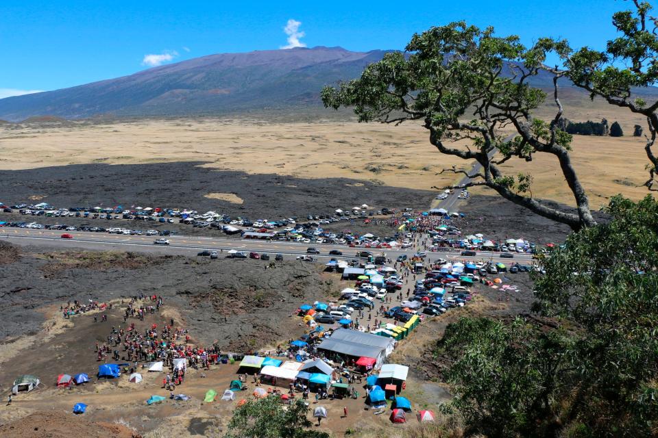 In this July 21, 2019, file photo provided by the Hawaii Department of Land and Natural Resources, protesters block a road to the summit of Mauna Kea in Hawaii. Astronomers across 11 observatories on Hawaii’s tallest mountain have cancelled more than 2,000 hours of telescope viewing over the past four weeks because a protest blocked a road to the summit, astronomers said Aug. 9.