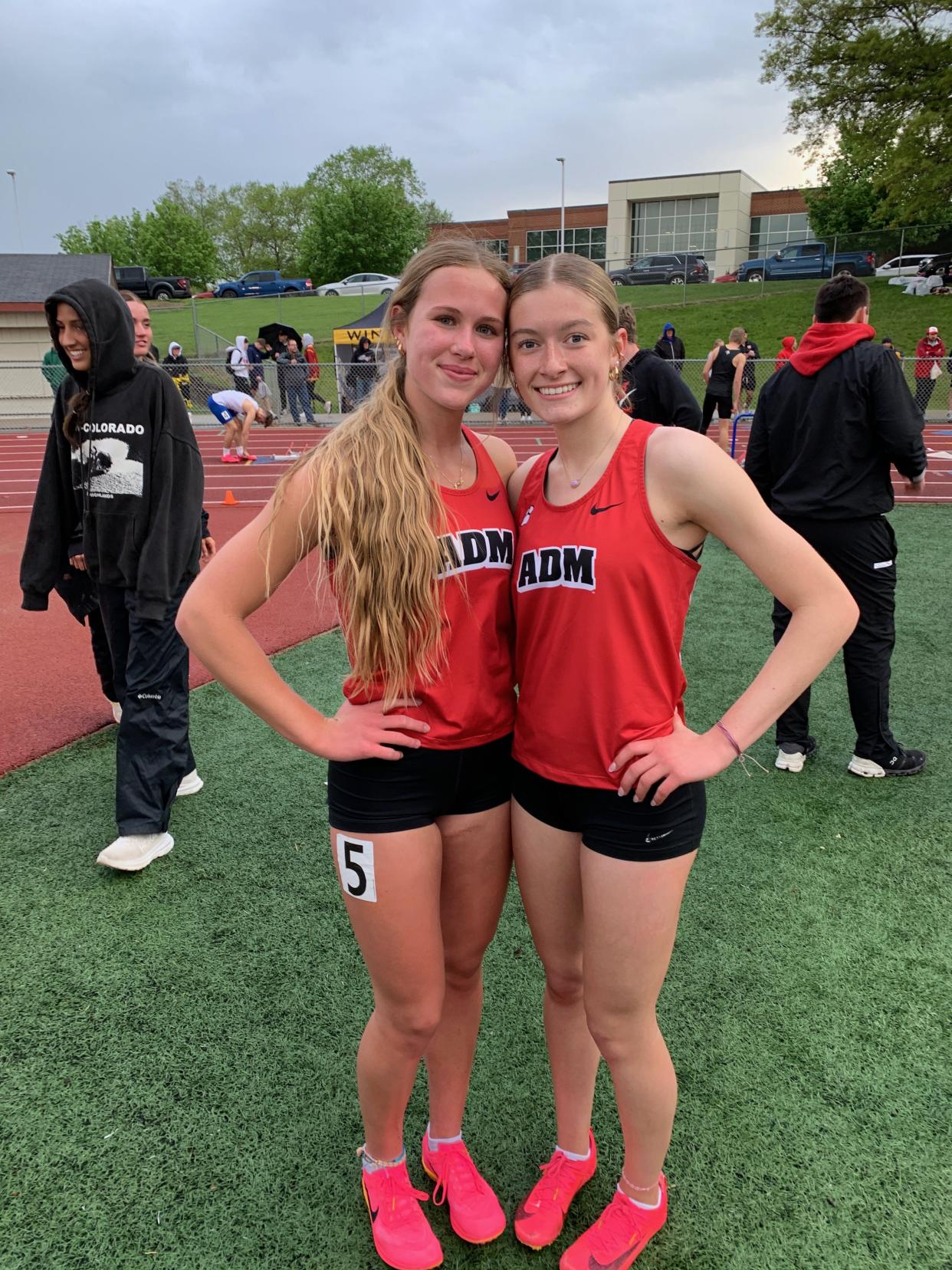 ADM's Madi James and Elise Coghlan pose for a photo after placing first and third in the 400-meter hurdles during the Raccoon River Conference meet on Wednesday, May 1, 2024 in Carlisle.