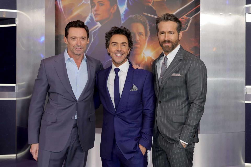 <p>Michael Loccisano/WireImage</p> (Left-right:) Hugh Jackman, Shawn Levy and Ryan Reynolds in 2022