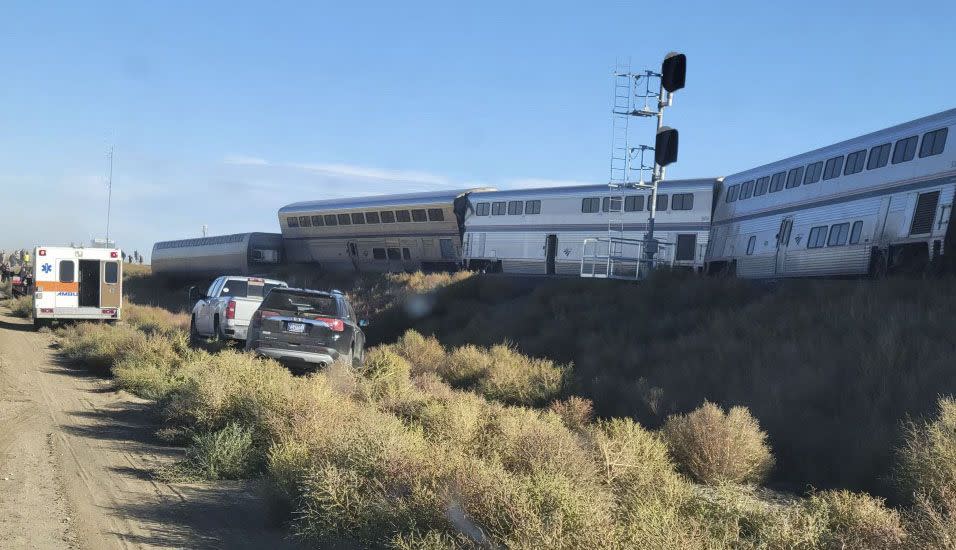 In this photo provided by Kimberly Fossen, an ambulance is parked at the scene of an Amtrak train derailment on Saturday in north-central Montana.