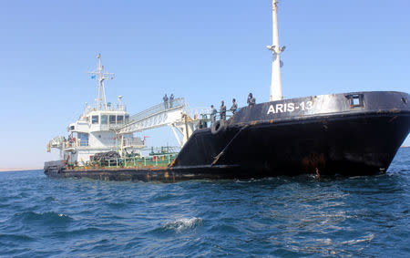 Maritime police are seen aboard oil tanker Aris-13, which was released by pirates, as it sails to dock on the shores of the Gulf of Aden in the city of Bosasso, northern Somalia's semi-autonomous region of Puntland, March 19, 2017. REUTERS/Abdiqani Hassan FOR EDITORIAL USE ONLY. NO RESALES. NO ARCHIVES. TPX IMAGES OF THE DAY