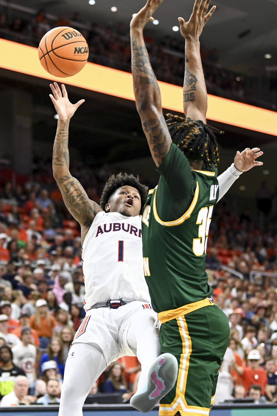 George Mason forward Malik Henry (35) fouls Auburn guard Wendell Green Jr. (1) during the second half of an NCAA college basketball game Monday, Nov. 7, 2022, in Auburn, Ala. (AP Photo/Julie Bennett)