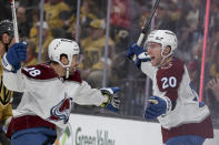 Colorado Avalanche left wing Miles Wood (28) and center Ross Colton (20) celebrate after Colton's goal against the Vegas Golden Knights during the first period of an NHL hockey game, Sunday, April 14, 2024, in Las Vegas. (AP Photo/Ian Maule)