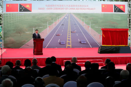 A general view shows Chinese President Xi Jinping (L) speaking during the opening ceremony of the China-Aid PNG Independence Boulevard Project ahead of the APEC summit in Port Moresby, Papua New Guinea, 16 November 2018. Mast Irham/Pool via REUTERS