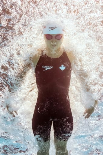 Canada's Margaret Macneil stunned the favourites in the women's 100m butterfly