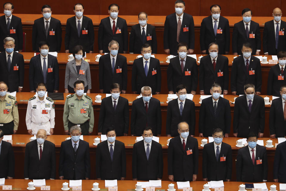 Delegates stand during the opening session of China's National People's Congress (NPC) at the Great Hall of the People in Beijing, Friday, May 22, 2020. (AP Photo/Ng Han Guan, Pool)