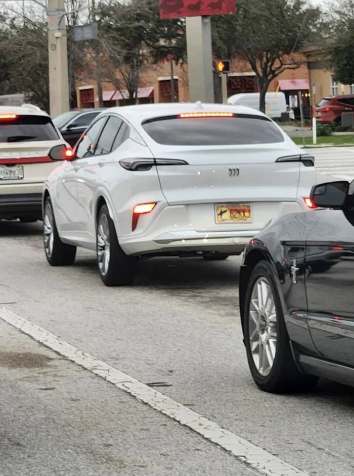 A car with lights very low on the bumper