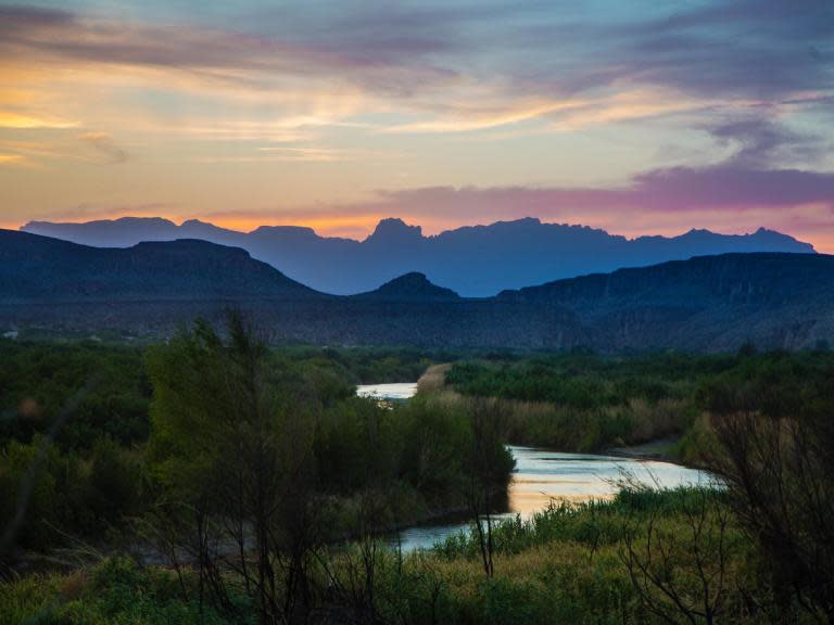 The bodies of what appeared to be a migrant woman in her 20s and three children – two infants and a toddler – were found on Sunday night near the edge of the Rio Grande outside the South Texas city of McAllen, authorities said.Migrant deaths happen with grim regularity along parts of the United States’ southwestern border, largely when adults and unaccompanied teenagers succumb to harsh desert conditions or a lack of water and die of dehydration, heat stroke or hypothermia.However, the discovery on Sunday was unusual – it is rare for officials to discover dead migrant children on the US side of the border and rarer still for the bodies of three children to be found together.“Most of the time we usually find either adults or teenagers, but this is the first time we’ve actually found infants and toddlers, and it is pretty shocking for us,” said Hidalgo County Sheriff J E Guerra, who broke the news of the discovery on Twitter late on Sunday night.Officials said there were as yet no signs of foul play and that the four may have died from dehydration and heat exposure. The bodies appeared to be those of immigrants in the country illegally, but neither their identities nor their country of origin had been determined on Monday.Migrants from El Salvador, Guatemala and Honduras have crossed the border by the thousands in recent months, overwhelming Border Patrol agents, nonprofit groups and local officials.The four bodies were found by Border Patrol agents across the river from Reynosa, Mexico, in an area on the US side of the border that is heavily travelled by Central American families. They were in a brush-covered region southeast of Anzalduas Park on federal property managed by the US Fish and Wildlife Service, near the state-run Las Palomas Wildlife Management Area, officials said.The FBI was leading the investigation because the bodies were found on federal land.“It’s an incredibly heartbreaking situation, which seems to happen far too often,” special agent Michelle Lee, a spokesperson for the FBI in San Antonio, said in a statement.Early on Monday morning, Anzalduas Park was quiet. The only noises were chirping birds and a slight ripple from the river, aside from the occasional Border Patrol truck or county constable vehicle driving by.The park – a 96-acre recreation area with picnic tables, playgrounds and a boat dock that is about 6 miles from downtown McAllen – has been a popular backdrop for visiting officials from Washington. Donald Trump passed through earlier this year during his only visit to the Texas-Mexico border as president.The area near the park along the Rio Grande has been a migrant-crossing hub in Hidalgo County. Migrant families with children cross the river here in small or large groups on makeshift rafts and then walk inland in search of Border Patrol agents so they can turn themselves in.Migrant deaths are more common far north of the river’s edge, on private ranchland deeper into South Texas. In those areas, water is harder to find, the terrain is more isolated and expansive, and migrants often hike for days ill-prepared for the journey.It was unclear what went wrong for the woman and children whose bodies were found: whether they had gotten lost in the brush in the heat, whether they were already ill when they crossed the river, whether they were abandoned by smugglers or other migrants.Mr Guerra said they were found in a makeshift staging area, a clearing near the river where groups of migrants often gather after they cross the river. From there, they typically walk deeper into the countryside to look for federal agents.South Texas is always hot in June, but the heat has been extreme in recent days.On Monday, the National Weather Service issued a “dangerous” heat advisory for the Rio Grande Valley region of South Texas, which includes McAllen. “Heat-related illnesses will likely occur for anyone working or playing outdoors for extended periods of time today,” the advisory said.Over the past week in the valley, temperatures have regularly approached or exceeded 100 degrees. On Wednesday, the temperature hit 108 degrees.The Rio Grande Valley is the busiest Border Patrol sector for migrant apprehensions on the nearly 2,000-mile border with Mexico.In May, a total of 132,887 migrant adults and children were apprehended between ports of entry on the entire southern border, an increase from 99,304 in April, according to Customs and Border Protection, the Border Patrol’s parent agency.Earlier this month, agents in the Rio Grande Valley sector apprehended more than 4,100 migrants in just three days.The New York Times