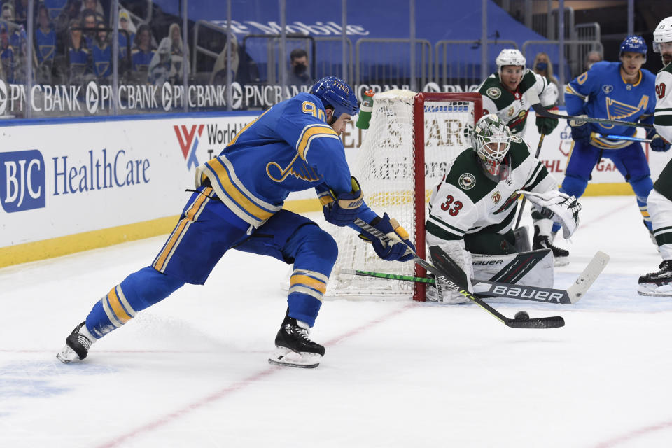 St. Louis Blues' Ryan O'Reilly (90) scores the winning goal past Minnesota Wild's Cam Talbot (33) during overtime of an NHL hockey game on Saturday, April 10, 2021, in St. Louis. (AP Photo/Joe Puetz)