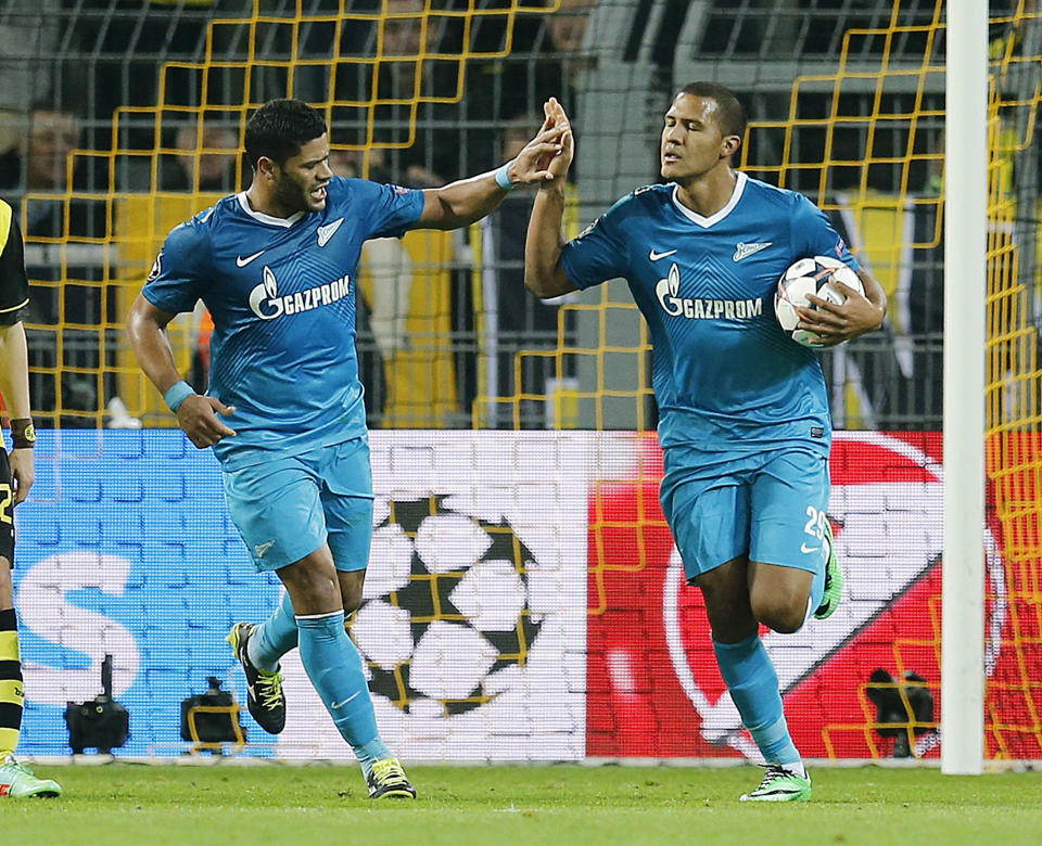 Zenit's Hulk, left, and Zenit's Rondon celebrate their side's second goal during the Champions League round of 16 second leg soccer match between Borussia Dortmund and FC Zenit in Dortmund, Germany, Wednesday, March19,2014. (AP Photo/Frank Augstein)