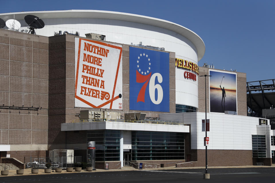 The Wells Fargo Center, home of the Philadelphia Flyers NHL hockey team and the Philadelphia 76ers NBA basketball team, is seen nearly empty, Saturday, March 14, 2020, in Philadelphia. All games at the Center have been postponed due to the COVID-19 pandemic. (AP Photo/Matt Slocum)