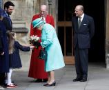 <p>Queen Elizabeth rarely steps out without a bright ensemble, like her Easter egg blue coat dress and matching hat in 2017. Her husband, Prince Philip, follows behind as she accepts a bouquet of flowers.</p>