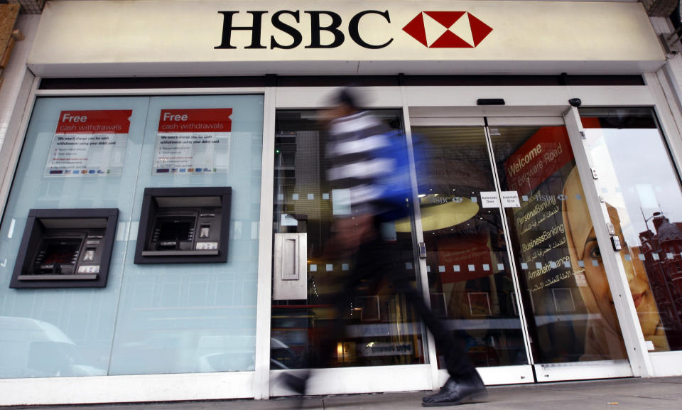 A pedestrian passes a branch of HSBC bank in London, Monday, Feb. 27, 2012. Buoyant trading in Asia helped HSBC Holdings PLC, Europe's biggest bank by market value, report a 28 percent increase in full-year profit Monday, a marked contrast to the performance of other big British banks. (AP Photo/Kirsty Wigglesworth)