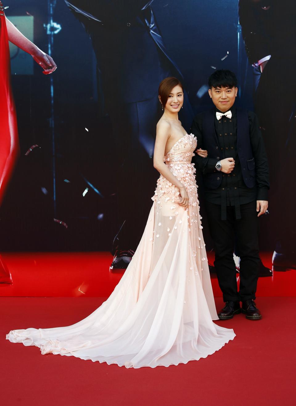 Angel Chiang, nominated for Best New Performer for her role in "A Secret Between Us", poses on the red carpet with director Patrick Kong during the 33rd Hong Kong Film Awards in Hong Kong April 13, 2014. REUTERS/Tyrone Siu (CHINA - Tags: ENTERTAINMENT)