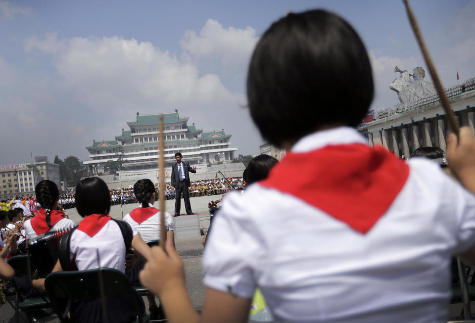 North Korean students in a concert band play music during a parade to celebrate the Korean War armistice agreement, Sunday, July 27, 2014, in Pyongyang, North Korea. North Koreans gathered at Kim Il Sung Square as part of celebrations for the 61st anniversary of the armistice that ended the Korean War. (AP Photo/Wong Maye-E)