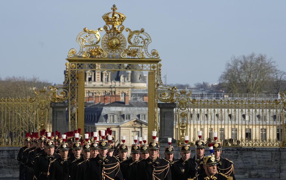 File - French Republican guards march, prior to leaders arrivals, during an EU summit at the Chateau de Versailles, in Versailles, west of Paris, on March 10, 2022. France is rolling out the red carpet for King Charles III's state visit starting on Wednesday Sept. 20, 2023 at one of its most magnificent and emblematic monuments: the Palace of Versailles, which celebrates its 400th anniversary. (AP Photo/Michel Euler, File)