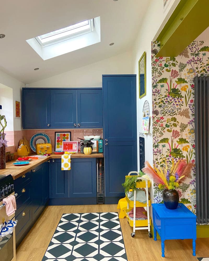 Skylight in colorful kitchen with blue cabinets.