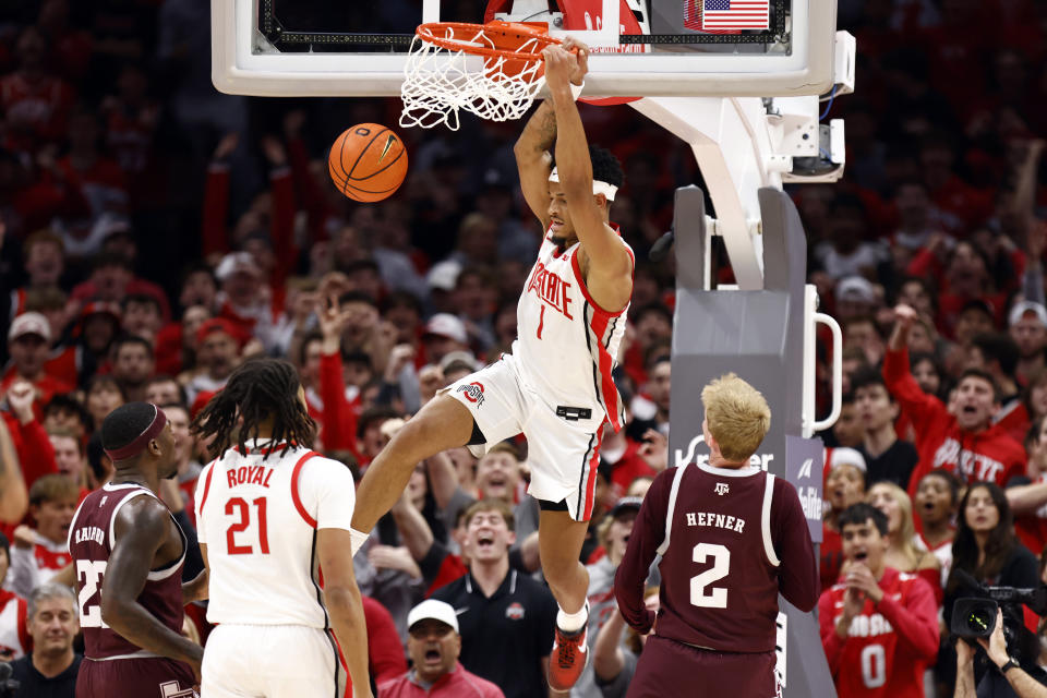 Ohio State guard Roddy Gayle (1) dunks in front of Texas A&M guard Tyrece Radford (23), Texas A&M guard Hayden Hefner (2) and Ohio State forward Devin Royal (21) during the first half of an NCAA college basketball game in Columbus, Ohio, Friday, Nov. 10, 2023. (AP Photo/Paul Vernon)