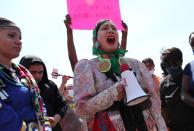 Miiskogihmiiwan, 19, a local indigenous woman, sings a song at a memorial for George Floyd that has been created at the place where he was taken into police custody and later died in Minneapolis