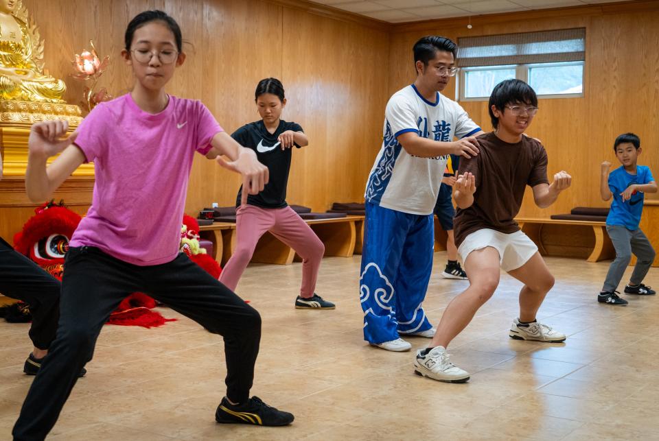 Lead instructor Kevin Gian leads drills during Heavenly Dragon Lion Dance Association practice at the Fo Guang Shan Xiang Yun Temple in Austin, May 11, 2024. The drills help dancers build the required strength and form to move the head and back of the costume properly.
