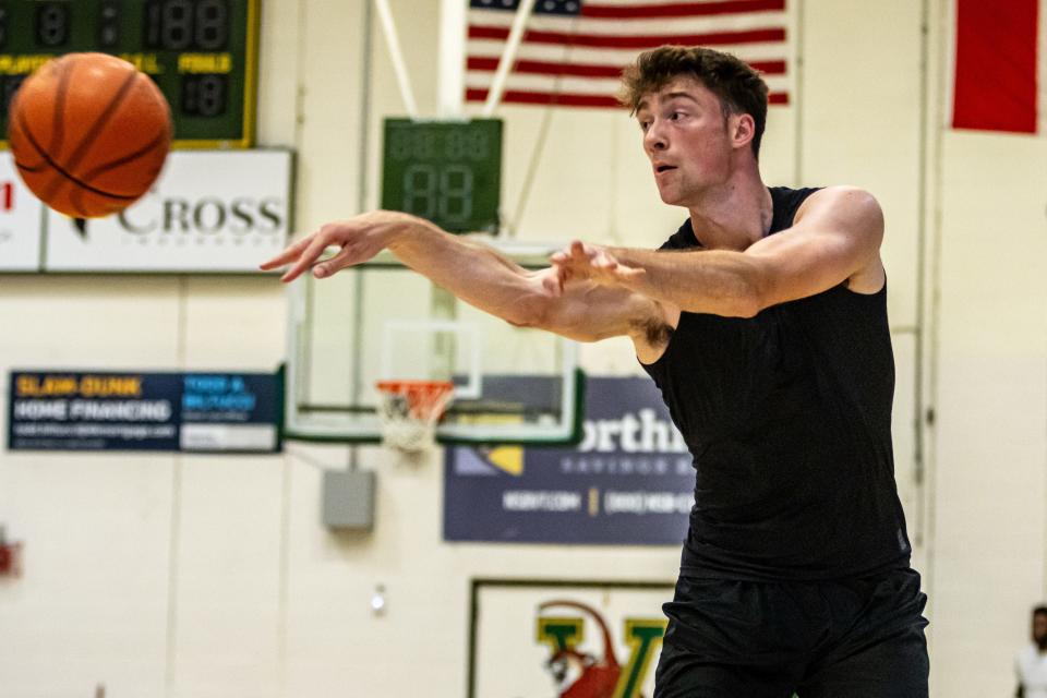 Nick Fiorillo flicks a pass during a UVM men's basketball summer practice at Patrick Gym.