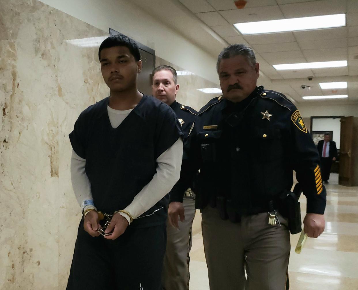 Jamez Sanchez is escorted out of the 140th District Court where he was sentenced to 30 years in prison for his role in the May 2021 drive-by shooting at a North Lubbock mobile home park that killed a 69-year-old Willard Justice Jr.