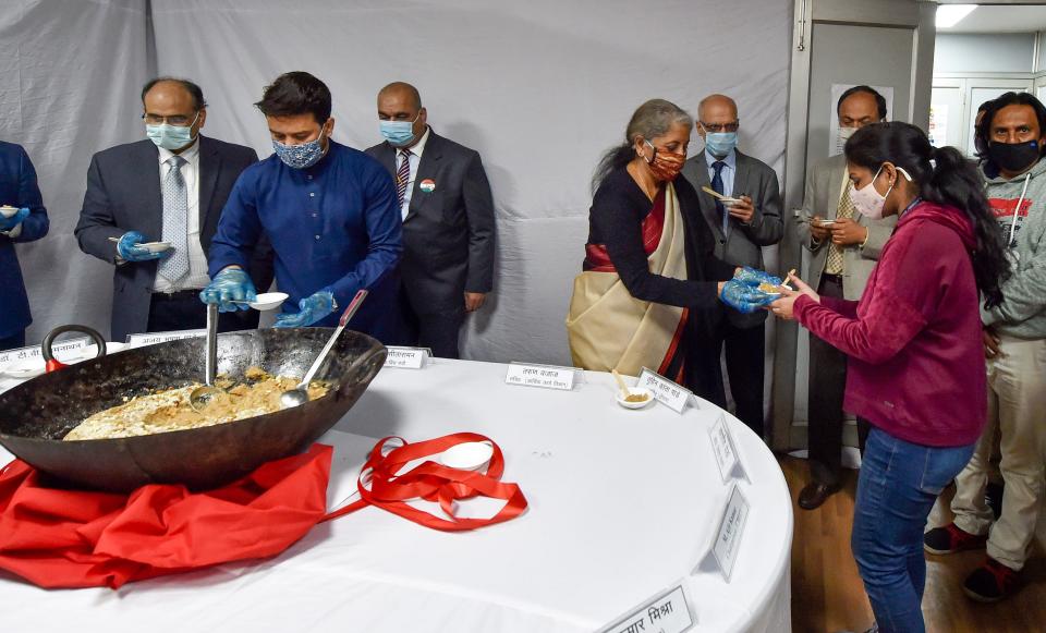 Finance Minister Nirmala Sitharaman distributing halwa, a sweet dish, during the ceremony.