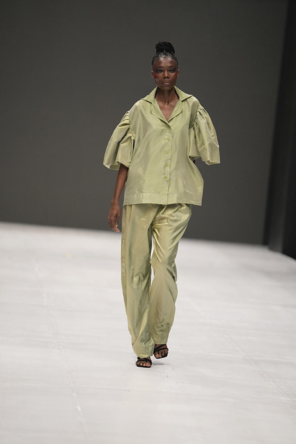 A model wears a creation by Kadiju during the Lagos Fashion Week in Lagos, Nigeria, Thursday, Oct. 26, 2023. Africa's fashion industry is rapidly growing to meet local and international demands but a lack of adequate investment still limits its full potential, UNESCO said Thursday in its new report released at this year's Lagos Fashion Week show. (AP Photo/Sunday Alamba)