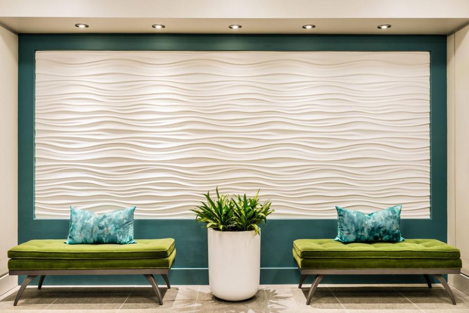 <p>A 3-D feature wall is stunning in this lobby designed by <a href="https://deringhall.com/interior-designers/jn-interior-spaces" rel="nofollow noopener" target="_blank" data-ylk="slk:JN Interior Spaces;elm:context_link;itc:0;sec:content-canvas" class="link ">JN Interior Spaces</a>.</p>