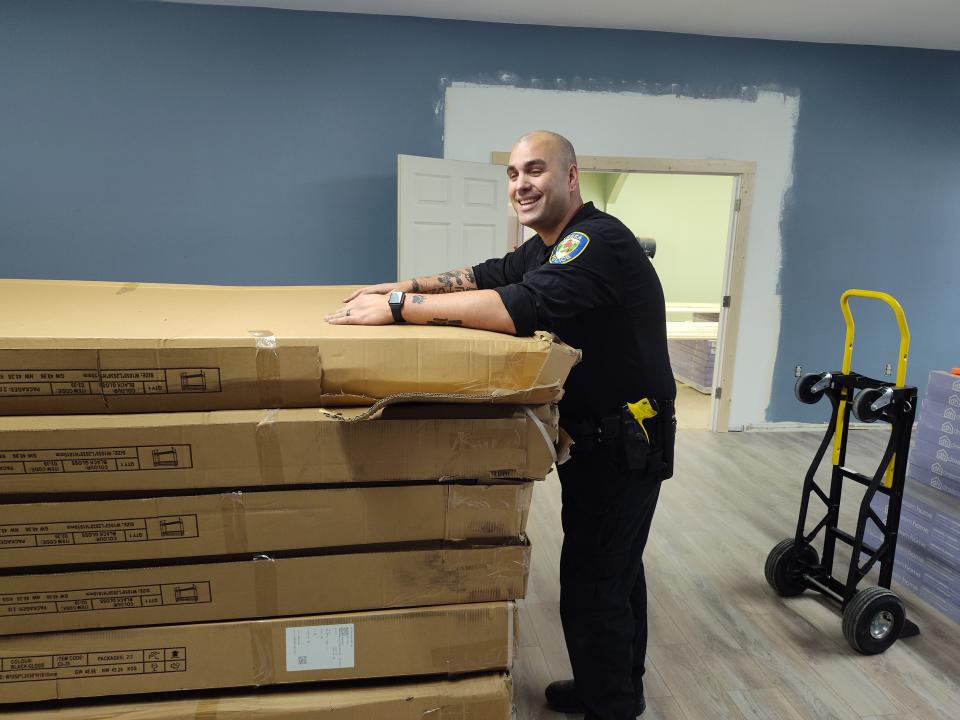 Yreka Police Officer James Elliot volunteers to help bring supplies into Yreka Basecamp, a low-barrier homeless shelter opening on South Main Street in summer 2024.