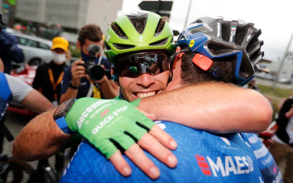 Mark Cavendish celebrates with his team-mate Dries Devenyn. - REUTERS