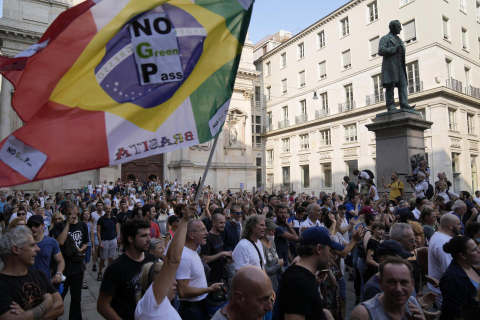 People stage a protest against the COVID-19 vaccination pass, in Milan, Italy, Saturday, July 24, 2021. Italy's government approved a decree ordering the use of the so-called "green" passes starting on Aug. 6. To be eligible for a pass, individuals must prove they have received at least one vaccine dose in the last nine months, recovered from COVID-19 in the last six months or tested negative in the previous 48 hours. The passes will be needed to dine at tables inside restaurants or cafes, to attend sports events, town fairs and conferences, and to enter casinos, bingo parlors and pools, among other activities. according to officials. (AP Photo/Antonio Calanni)