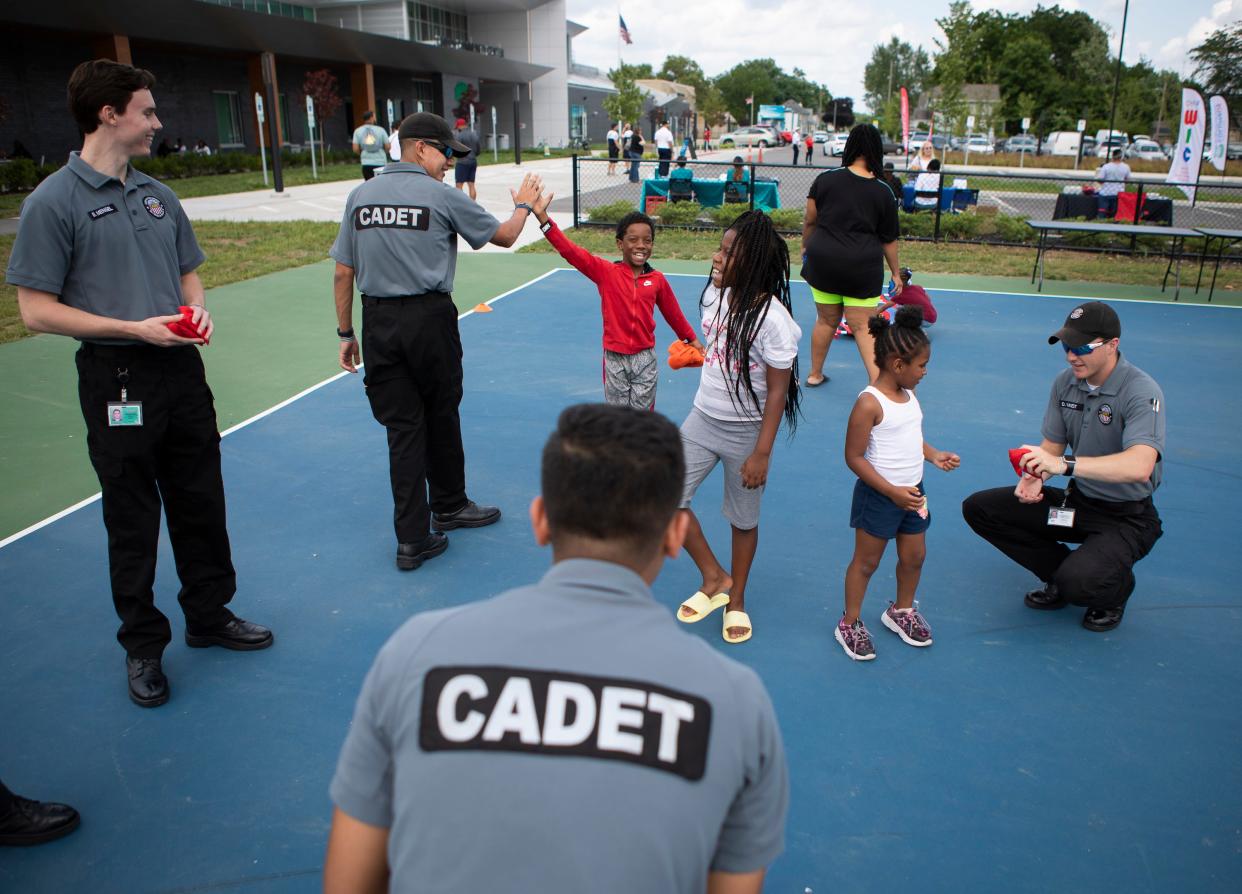 Police cadets play cornhole with a group of kids during a Summer Block Party hosted by the Columbus Division of Police and The Starfish Assignment at the Linden Community Center on Friday, July 9, 2021. The event was the first of a series behing held on Fridays in July at locations throughout the city.