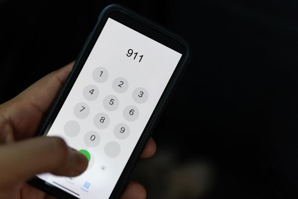 <p>Getty</p> A person dialing 911  (stock photo)