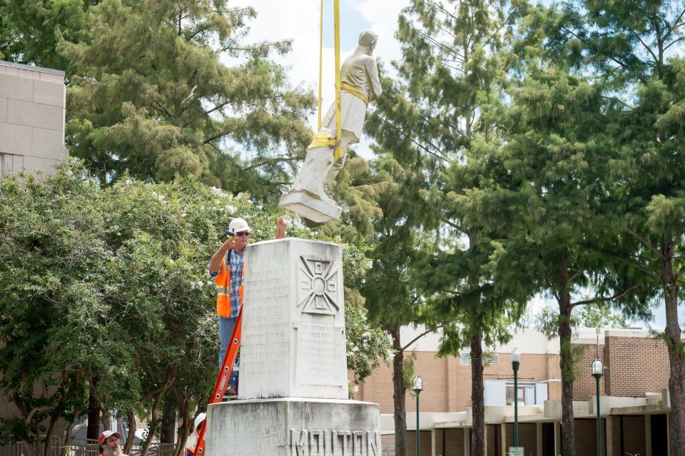 After 99 years at the corner of Jefferson Street and Lee Avenue in downtown Lafayette, the statue of Confederate Gen. Alfred Mouton is removed.  Saturday, July 17, 2021.