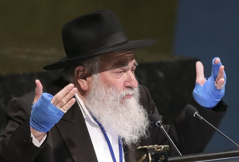 FILE - In this June 26, 2019, file photo, Rabbi Yisroel Goldstein, senior rabbi of Chabad of Poway synagogue in San Diego, Calif., addresses the United Nations General Assembly's meeting on combating antisemitism and other forms of racism and hate in the digital age at U.N. headquarters. The rabbi who had part of his hand shot off in a deadly attack at his Southern California synagogue pleaded guilty Tuesday, July 14, 2020, to federal charges of tax and wire fraud, according to a newspaper report. Rabbi Goldstein, 58, acknowledged his role in a scheme in which donors made large contributions to Chabad of Poway but then secretly got most of the money back, the San Diego Union-Tribune reported. (AP Photo/Bebeto Matthews, File)