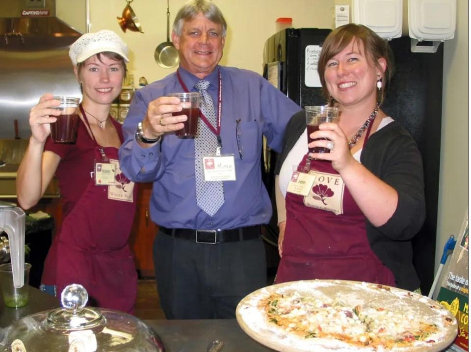 Mitchell Booth, center, celebrates the one-year anniversary of the Love Whole Foods Cafe & Market at 1633 Taylor Road in Port Orange with two employees in October 2012.