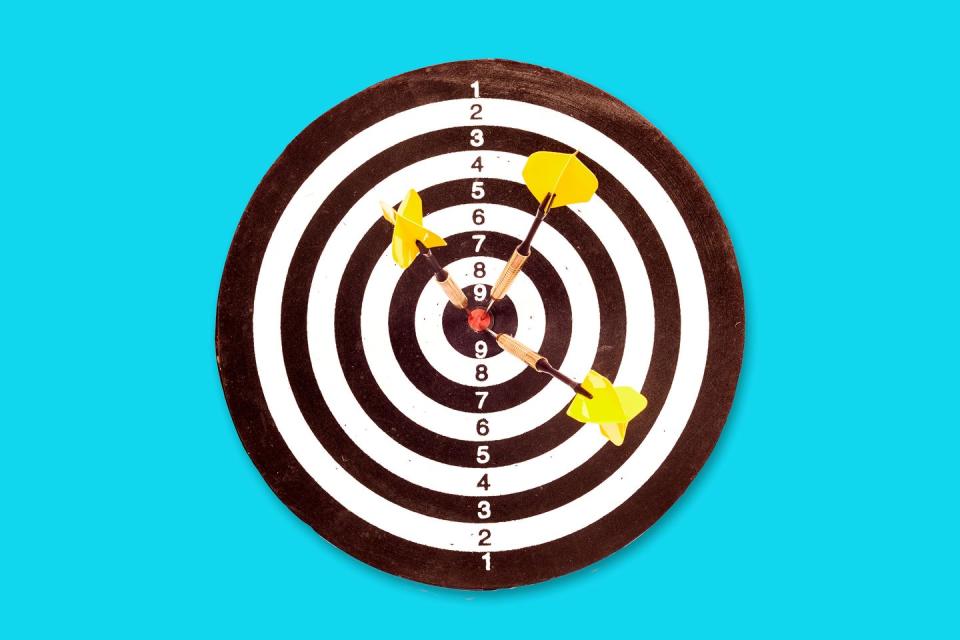 a dart board with three darts in the center