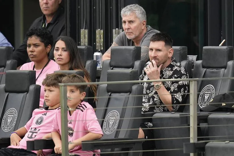 Inter Miami forward Lionel Messi, right, watches from his sideline box during the first half of an MLS soccer match against CF Montreal, Sunday, March 10, 2024, in Fort Lauderdale, Fla. (AP Photo/Rebecca Blackwell)