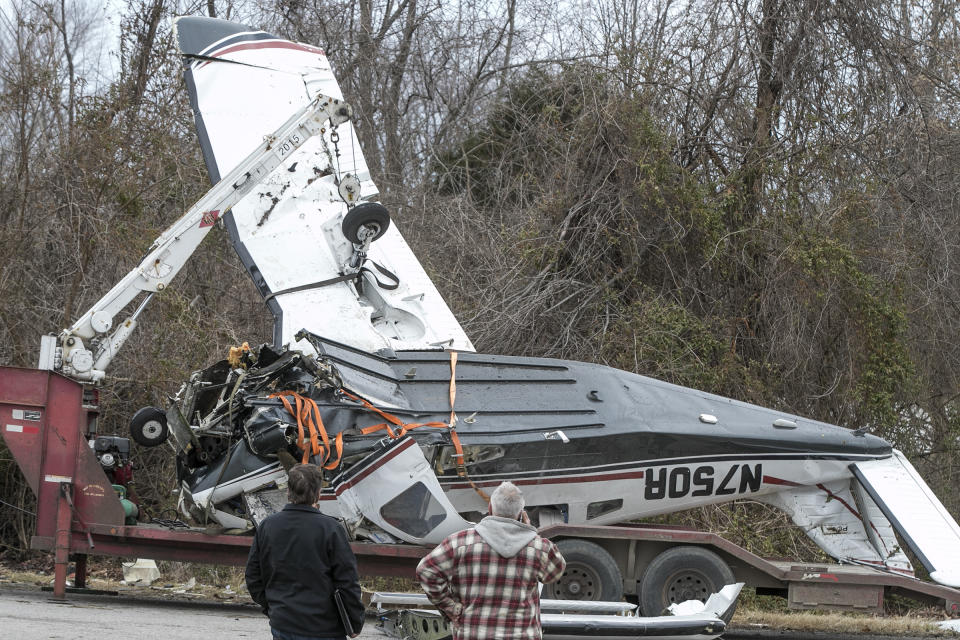 Workers prepare the wrecked plane for transport Wednesday, March 13, 2019, in Waterloo, Ill. The family who survived the Tuesday plane crash near Waterloo are from Alabama and were taken to area hospitals with minimal injuries. (Derik Holtmann/Belleville News-Democrat via AP)