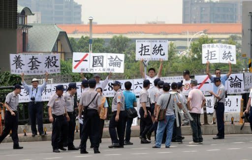 Anti-China activists display placards reading, "refuse unificiation with China" outside the venue of the eighth Taiwan and China trade talks in Taipei. Some Taiwanese fear a new trade pact with China will strengthen Beijing's hold over the island, and protesters have been tailing China's chief negotiator Chen Yunlin since his arrival on Wednesday