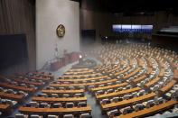 Employees from a disinfection service company sanitize the National Assembly in Seoul