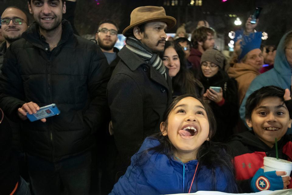 A young New Year's Eve celebrant watches the fireworks after the ball drop during New Year's Eve on the Square on Wednesday, January 1, 2020.